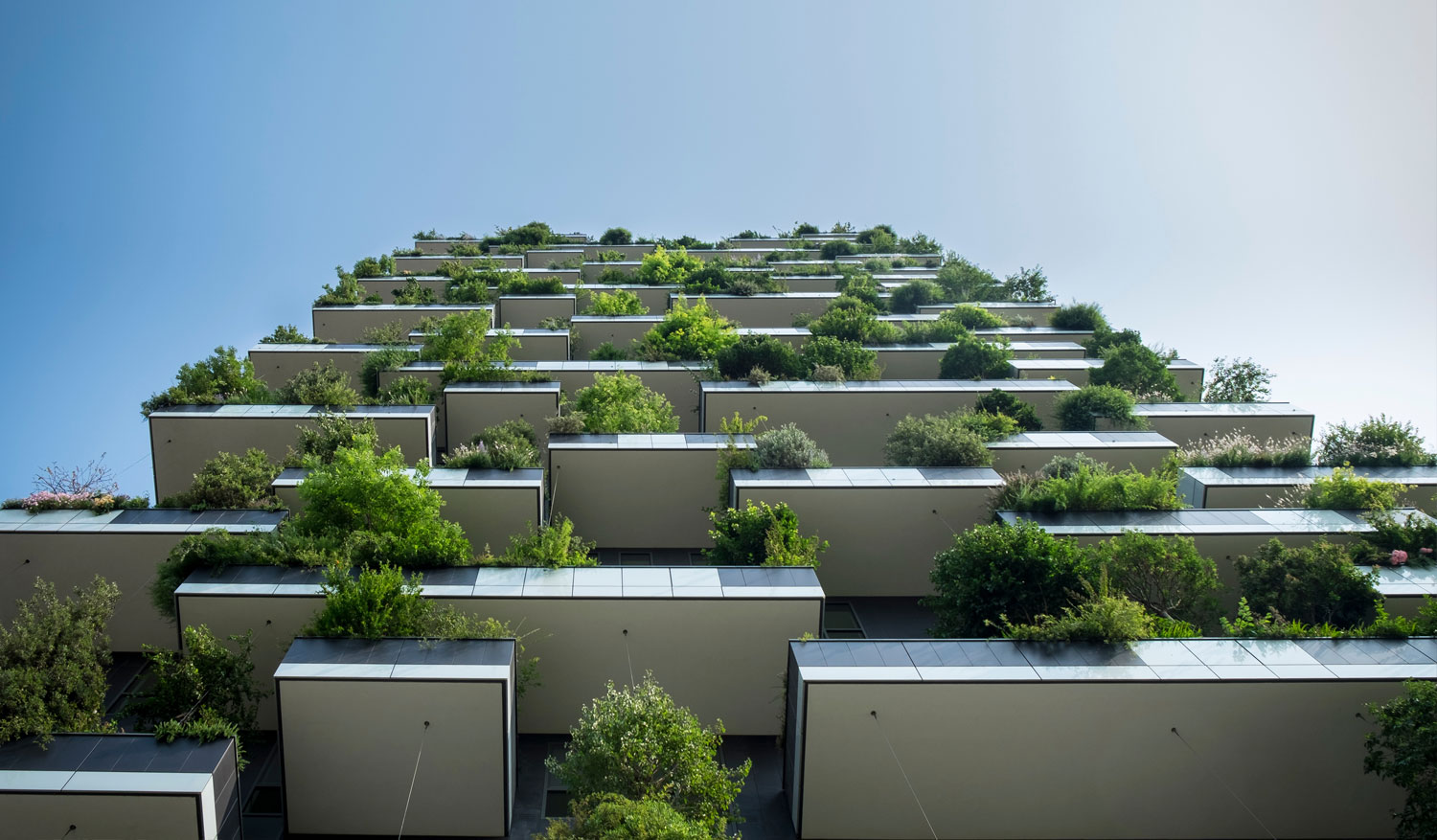 Unique building with greenery cascading off balconies.