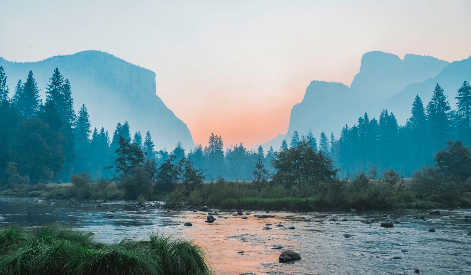 Idyllic valley with a pond in the middle of mountains.